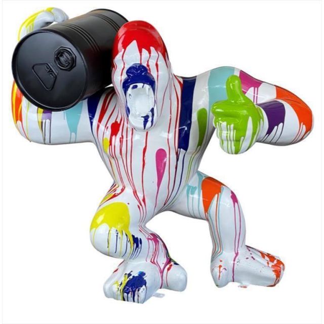 Sculpture gorilla white with colorful splash carrying a black barrel