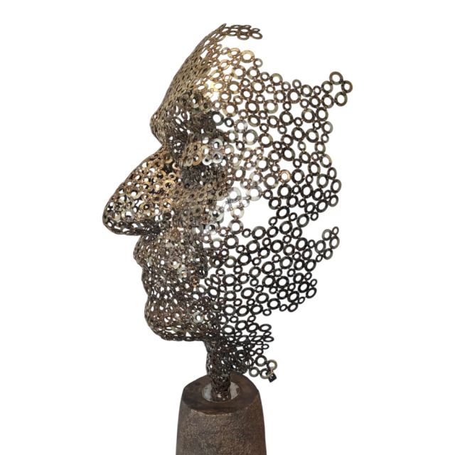 Sculpture face on base made of metal rings